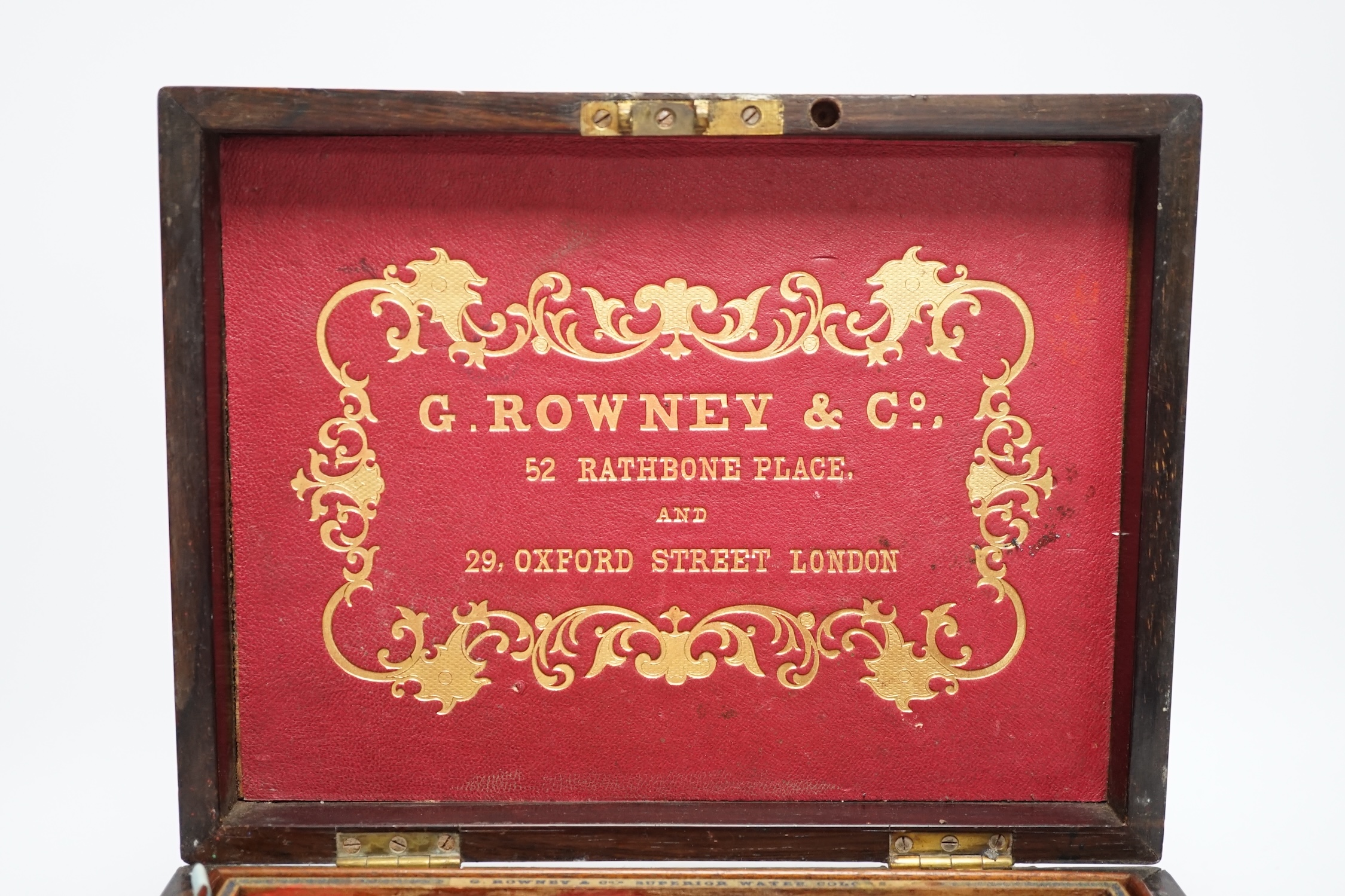 An Edwardian G Rowney & Co brass mounted artist’s paint box with watercolour blocks, tubes and charcoal sticks